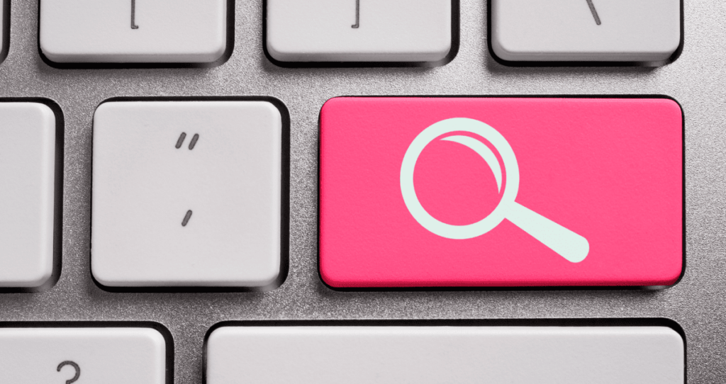 A keyboard with one red key that has a magnifying glass symbol