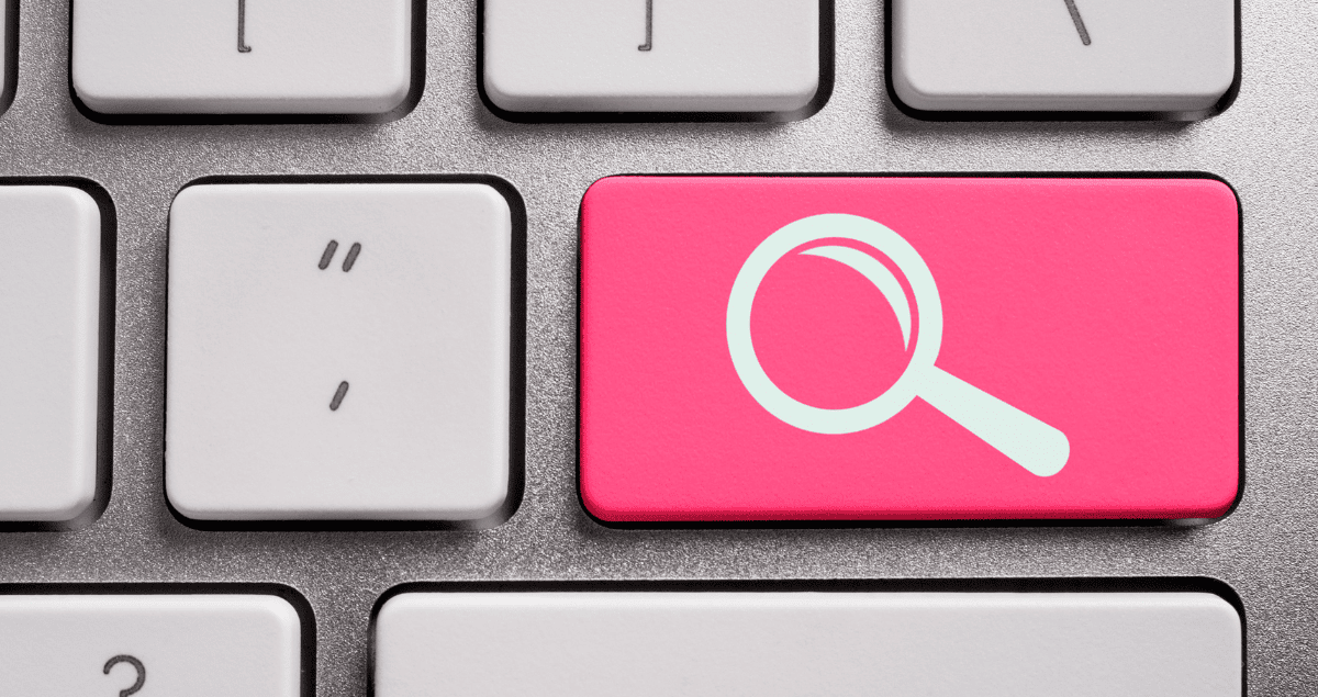 A keyboard with one red key that has a magnifying glass symbol